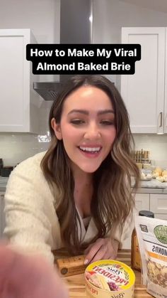 a woman sitting at a table with some food in front of her and the words how to make my virtual almond baked brie