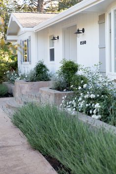 an instagram page with flowers and plants in front of a house