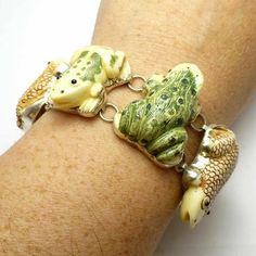 a close up of a person's arm wearing a bracelet with elephants on it