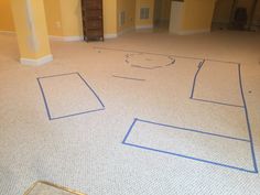 an empty room with blue lines on the floor