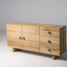 a wooden dresser sitting on top of a white floor