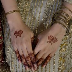 two hands with hendi tattoos on them