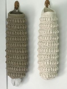 two crocheted items hanging on the wall