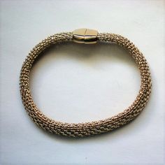 This fabulous woven chain bracelet is signed Monet and looks as if it is pure 18K gold.  The piece is 7½ inches in length and ¼ inch wide with a hidden magnetic clasp.  It is in excellent condition and looks as if it has never been worn. Thanks for looking and visiting my shop.  Please view the shop often as I regularly add new and interesting items and offers are always considered. Golden Co, Woven Chain, Magnetic Clasp, Chain Link Bracelet, Link Bracelets, Arm Band, Chain Bracelet, Chain Link, 4 Inch