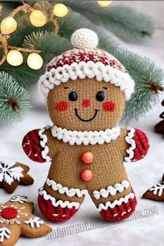 a knitted ginger is standing next to some cookies