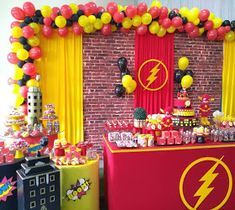 the flash man birthday party is set up with balloons, candy bars and other decorations