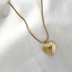 This 18k gold heart locket necklace embodies coquette jewelry, making it a dainty gift idea for her, ideal for women who appreciate minimalist and vintage-inspired accessories.💛 𝐃𝐄𝐓𝐀𝐈𝐋𝐒:  ⭐️ Necklace lengths available: 16" & 18" ⭐️ Gold Heart Locket charm size: 23x19mm ⭐️ 18k gold Stainless Steel  ⭐️ Perfect as everyday gold necklace, The Sweetheart necklace  ⭐️ ALL jewelry include 1 year warranty only for broken or discolored pieces  𝐇𝐎𝐖 𝐓𝐎 𝐎𝐑𝐃𝐄𝐑 1. Select quantity  2. Select Gold Heart Locket Necklace, Dainty Women, Coquette Jewelry, Locket Necklace Vintage, Gold Heart Locket, Gold Locket Necklace, Minimalist Vintage, Heart Charm Necklace, Tiktok Shop