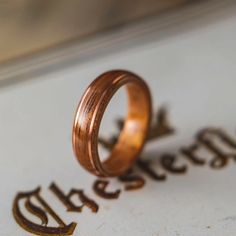 two wedding rings sitting on top of a piece of paper