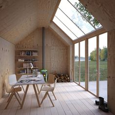 a room with wooden walls and flooring that has glass windows