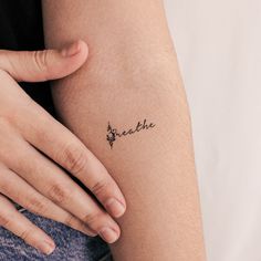 a woman's arm with the word breathe tattooed on her left side ribcage