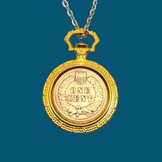 Cleaned reverse side of an Indian penny necklace set in a gold colored bezel tray in the shape of a pocket watch.  Perfect gift for anniversaries, Christmas, or any other gift giving occasion.  These pennies were only made from 1859 to 1909.  You will receive a coin with a random date during that period.   The pendant is about 1 1/16" wide x 1 1/2" high.  Please see the images for scale.   Includes your choice of silver toned chain lengths as shown in the images.   I only use the best coins that I have available. These are circulated coins, so they may have blemishes such as scratches or nicks.  All of these Indian head cents are well over 100 years old.   As with any copper, these pennies will develop a patina over time.   Chain may vary from the ones shown in the images. Veteran owned bu Antique Coin Jewelry Gift, Heirloom Gold Pocket Watch Collectible, Victorian Coin Pendant Jewelry For Gift, Victorian Style Coin Pendant Jewelry For Gift, Victorian Coin Pendant Jewelry Gift, Gold Cameo Locket Necklace Collectible, Heirloom Yellow Gold Pocket Watch As Gift, Heirloom Gold Pocket Watch As Gift, Gold Pocket Watch Collectible