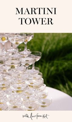 there are many wine glasses stacked on top of each other with the words martini tower