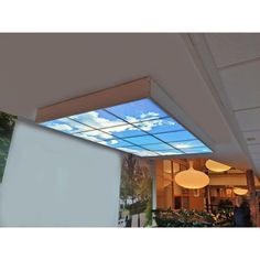 the sky is reflected in the glass on the ceiling