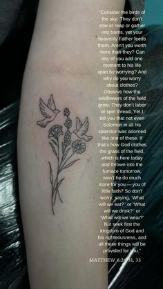 a black and white photo of a flower tattoo on the left side of a woman's arm