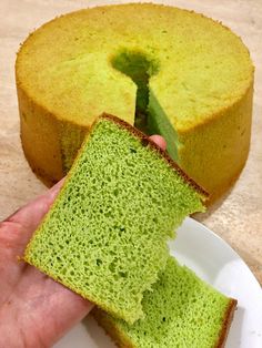 a person is holding a piece of green cake