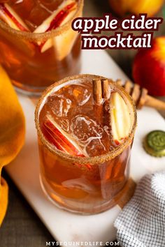 apple cider mocko cocktail with cinnamon stick garnish on the rim and apples in the background