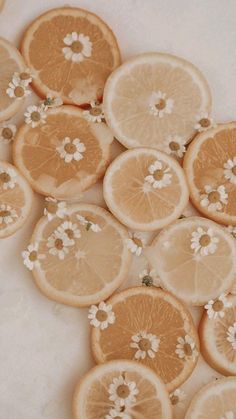 several slices of oranges with tiny white flowers on them are arranged in a pattern