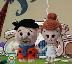 two crocheted dolls are holding hands