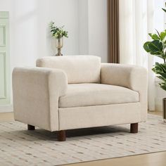 a living room with a chair and potted plant