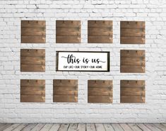 a white brick wall with wooden planks and a sign that says, this is us