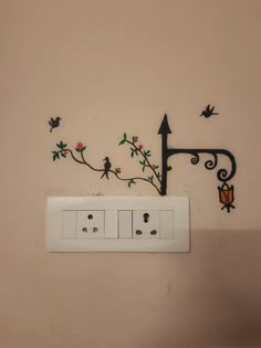 the electrical outlet is decorated with flowers and birds