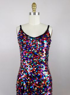 "This fun vintage party dress! It is fully embellished with rainbow paillette sequins and in excellent condition! Size SMALL Measurements: Bust - 32\" Waist - 26\" Hips - 36\" Length - 34\" Tag Size - 4 / Small (please refer to measurements) Size MEDIUM Measurements: Bust - 34\" Waist - 28\" Hips - 38\" Length - 33\" Tag Size - 6 /Medium (please refer to measurements) This dress comes from a pet-free and smoke-free home. If you would like more info or have any questions, please don't hesitate to Rainbow Hoco Dress, Disco Style Sequined Festival Dresses, Disco Style Sequined Dresses For Festivals, Fitted Sequin Dress For Festival, Multicolor Sequin Fabric For Disco In Summer, Multicolor Festival Dresses For Party, Fitted Sleeveless Sequin Dress For Festivals, Sleeveless Sequin Festival Dresses, Multicolor Disco Sequin Dress For Summer