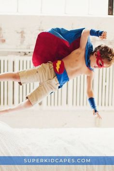 a young boy in a superman costume jumping on a bed with the caption super kid capes