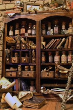 an old wooden bookcase filled with lots of books and knick - knacks