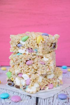 two pieces of rice krispy treats stacked on top of each other in front of pink background