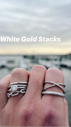 someone is holding their wedding and engagement rings with the words white gold stacks on it