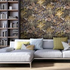 a living room filled with furniture and bookshelves next to a wall covered in flowers