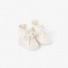 Our comfortable, hand-crocheted Garter Knit Baby Booties are the perfect, soft-sided shoe for little one's tiny feet, ages 0-12M. Made with an adjustable drawstring bow to keep shoe on. The 100% cotton knit baby booties feel dreamy, keep baby's feet warm, and add style and cuteness to any outfit. Choose from 4 gorgeous colors. Pair these booties with our Sofia + Finn Knit Baby Cardigan a sweet and luxurious gift. We also offer a variety of socks and booties for every occasion and outfit. Add our White Nutcracker, White Garter, Baby Easter Gifts, Color Whisper, Pom Pom Baby, White Garters, Knitted Baby Cardigan, Knit Baby Booties, Knitted Booties