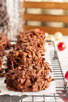 chocolate pretzels on a cooling rack with christmas decorations in the backgroud