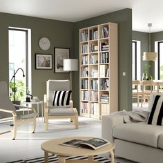 a living room filled with furniture and a book shelf