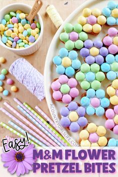 colorful marshmallow pretzel bites on a white plate with pink and purple straws