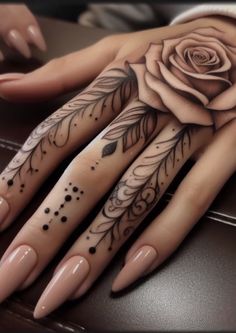 a woman's hand with tattoos on it and a rose tattooed on the palm