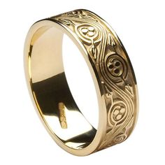 a gold wedding ring with an intricate design