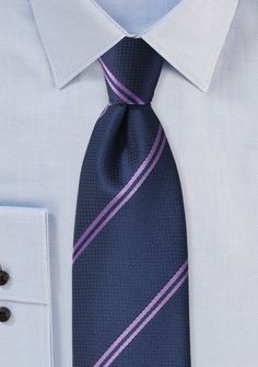 Enhance your formal ensemble with the charming Navy and Lavender Narrow Striped Necktie. Whether you're shopping for men's suits or preparing for a special event, this necktie exudes timeless elegance. The combination of deep navy and soft lavender creates a striking contrast that catches the eye. The narrow striped pattern adds a touch of sophistication and refinement, elevating your overall look. This necktie pairs exceptionally well with navy or gray suits, adding a pop of color and personali Dapper Ties For Office, Semi-formal Fitted Purple Suit And Tie Accessories, Classic Lavender Tie For Business, Elegant Lavender Suit And Tie Accessories For Business, Classic Purple Neckwear For Formal Occasions, Formal Purple Neckwear With Ties, Formal Lavender Suit And Tie Accessories, Elegant Purple Neckwear For Black Tie Event, Elegant Lavender Standard Tie