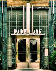 an entrance to a building with green and gold tiles on the front door that says parkdale