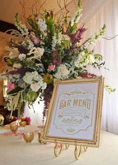 there is a sign that says bar menu on the table next to flowers and candles