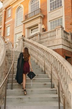 a woman is walking down the stairs with her suitcase in hand and she's going up