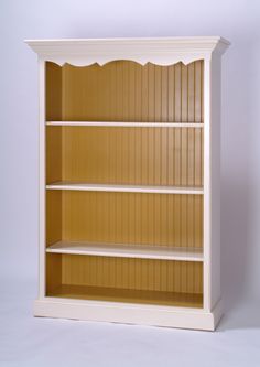 an empty white bookcase against a plain background