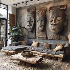 a living room filled with lots of furniture and art on the wall next to a window