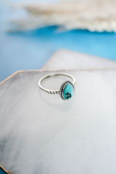 The perfect simple but cute, all day, every day ring! This dainty pear shaped genuine turquoise ring with rope detailing surrounding the stone and a studded detail band is set in 925 sterling silver. This is one of our best sellers, so you can't go wrong with this cutie for you, or as a gift! 925 Sterling Silver Natural, genuine turquoise Stone Size 9mm x 7mm‍ Nickel Free Hypoallergenic Please Note Turquoise is a natural stone and varies in color from blue to green and many shades in between. So Promise Rings Turquoise, Simple Turquoise Ring, Handmade Turquoise Jewelry, Western Rings, Silver Smithing, Ring Inspo, Silver Turquoise Jewelry, Ring Turquoise, Turquoise Ring Silver