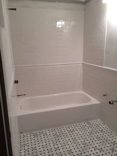 a white bath tub sitting inside of a bathroom