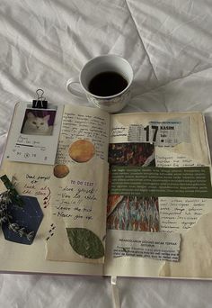 an open book with pictures and writing on it next to a cup of coffee or tea