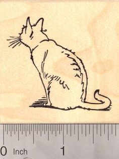 a rubber stamp with a drawing of a cat on it's back and measurements