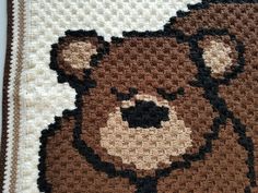 a crocheted teddy bear rug on the floor