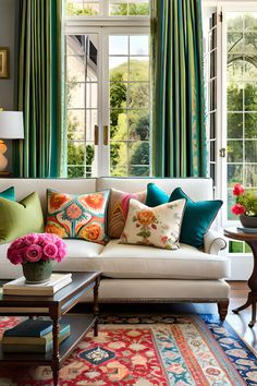 a living room filled with lots of furniture and colorful pillows on top of the couch