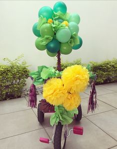 a bike decorated with flowers and balloons